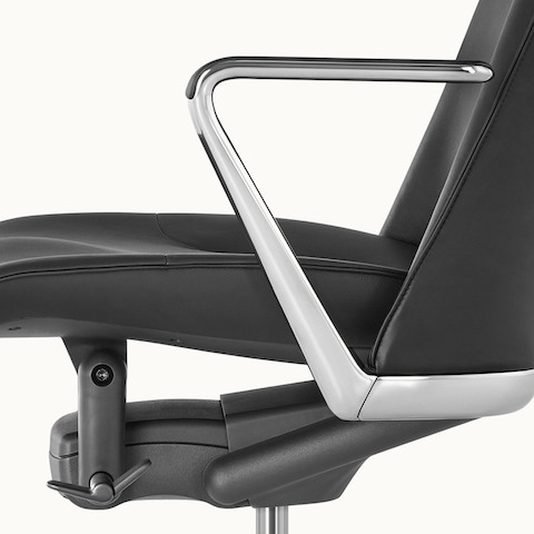 Close-up of the suspended seat on a Taper office chair, viewed from the side.