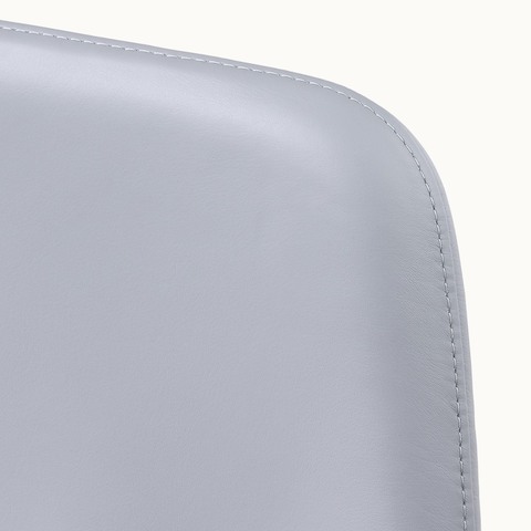 Close-up of an upper corner on the back of a Taper office chair, showing the single stitch option.