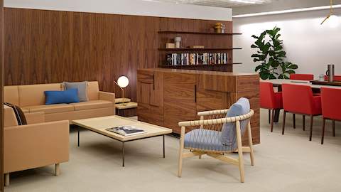 A sitting area featuring Tuxedo Classic Lounge Seating in light brown leather upholstery and a light blue Crosshatch Chair.