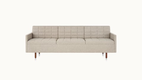 A quilted Tuxedo Classic sofa upholstered in bone-colored fabric, viewed from the front.