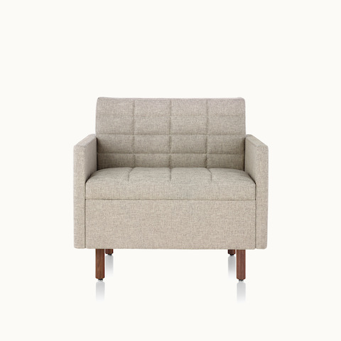 A Tuxedo Classic club chair with bone-colored quilted upholstery, viewed from the front.