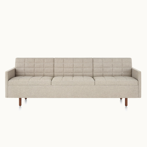A Tuxedo Classic sofa with bone-colored quilted upholstery, viewed from the front.