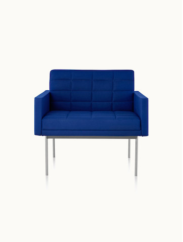 A quilted Tuxedo Component club chair upholstered in blue fabric, viewed from the front.