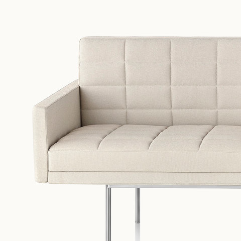 Partial front view of an ivory-colored Tuxedo Component sofa, showing the optional quilted upholstery.