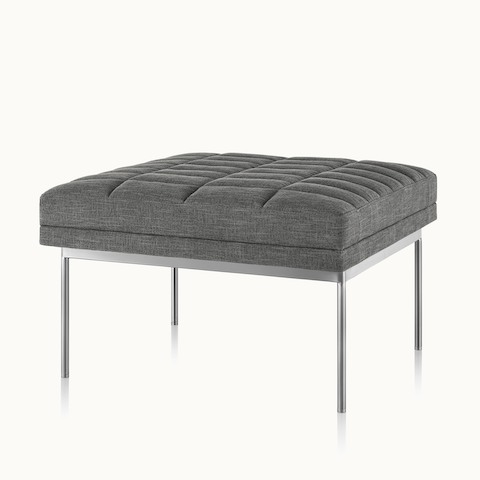 A Tuxedo Component Ottoman with neutral upholstery and a metal base, viewed at an angle.