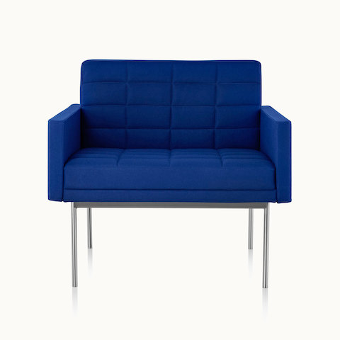 A quilted Tuxedo Component club chair upholstered in blue fabric, viewed from the front.