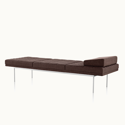 Angled view of a quilted Tuxedo Component daybed upholstered in dark brown fabric.