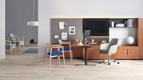 An executive office featuring Geiger Rhythm Casegoods, a gray leather Saiba office chair, and Crosshatch side and lounge chairs.