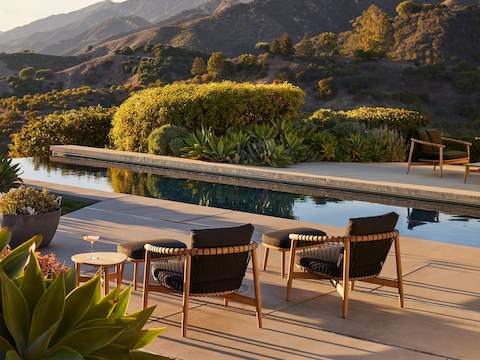 Crosshatch Outdoor Lounge Chairs with Ottomans in an environmental setting by the pool.